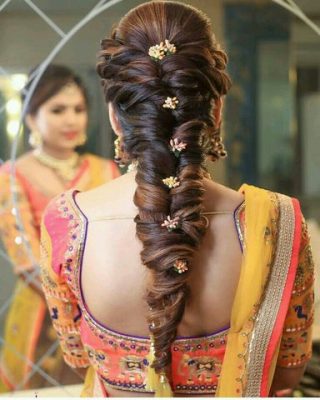 fishtail braid adorned with flowers, small beads, etc