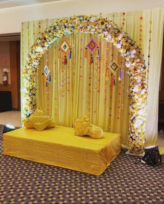 floral arch backdrop with boho touch for haldi decoration