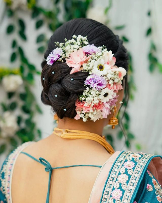 low bun covered halfway with flowers - bridal hairstyles