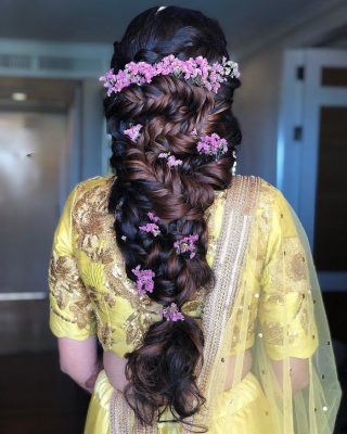 multi braided hairstyle with lilac flowers