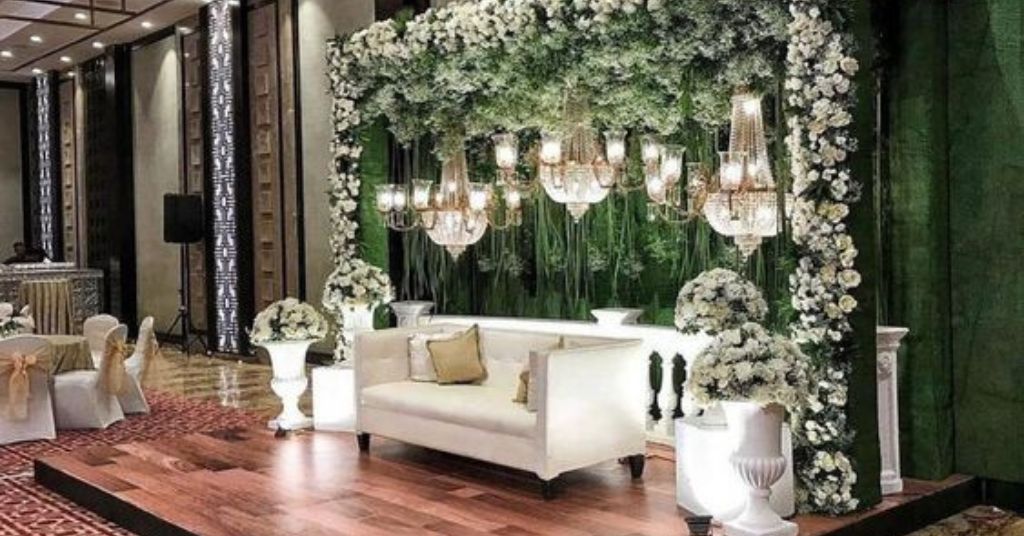 green lush luxurious engagement stage decoration