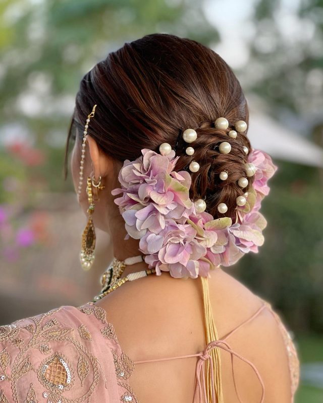 twisted bun with pearls and flowers - lehenga hairstyles