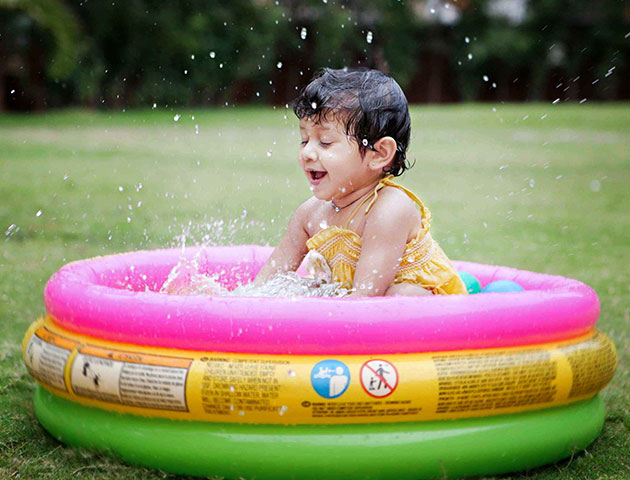 creative baby photoshoot in a baby pool