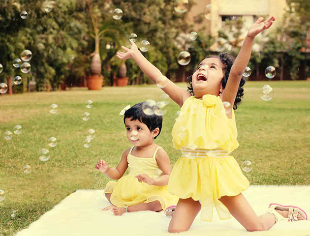 creative baby photoshoot with soap bubbles flying around