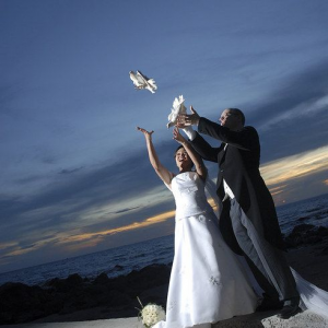 Filipino couple releasing a pair of doves as a symbol of harmonious start to their married life. 