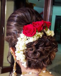 Bun Hairstyles for the Bride_low curls bun with flowers