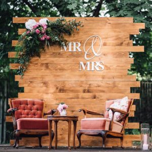 mr and mrs backdrop with two vintage chairs