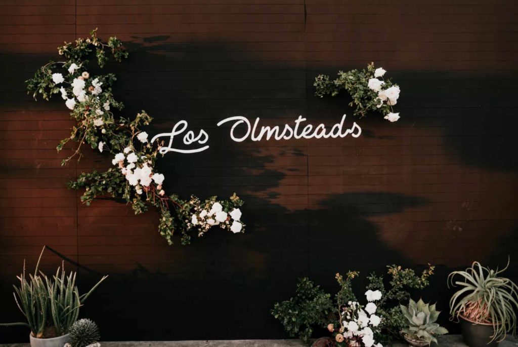 neon wedding signs on dark wood