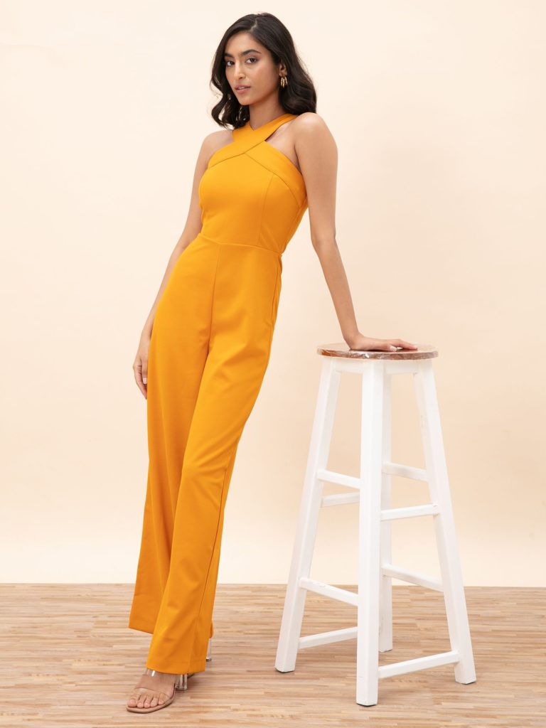 yellow criss cross neckline jumpsuit as bachelorette party dress ideas