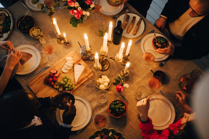 Directly above shot of friends enjoying food at dinner party