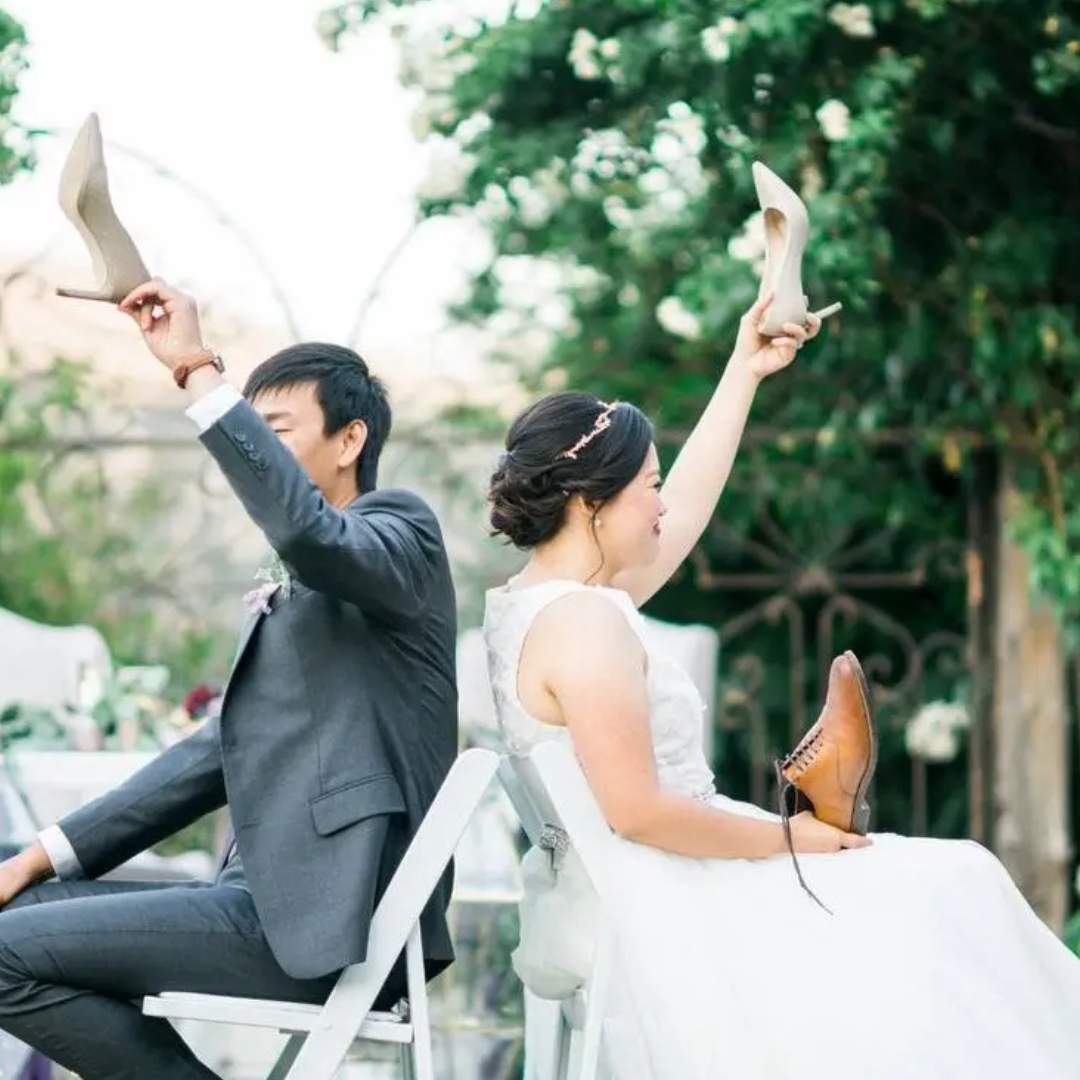 Couple sitting on the chairs faced back to back