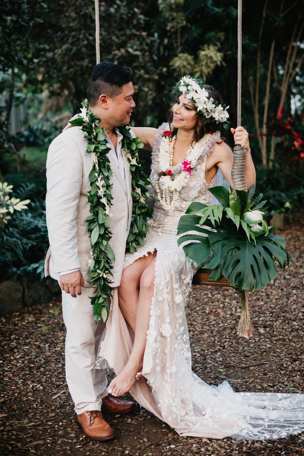 Bride and groom dressed in tropical-inspired, wind-friendly beach wedding outfits