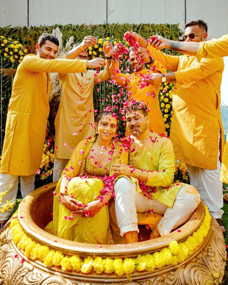 Haldi ceremony couple pose with family