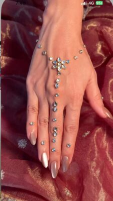 embellished mehendi design on bride hands for reception look