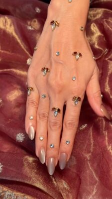 bridal hands with embellished mehendi and kundan stones