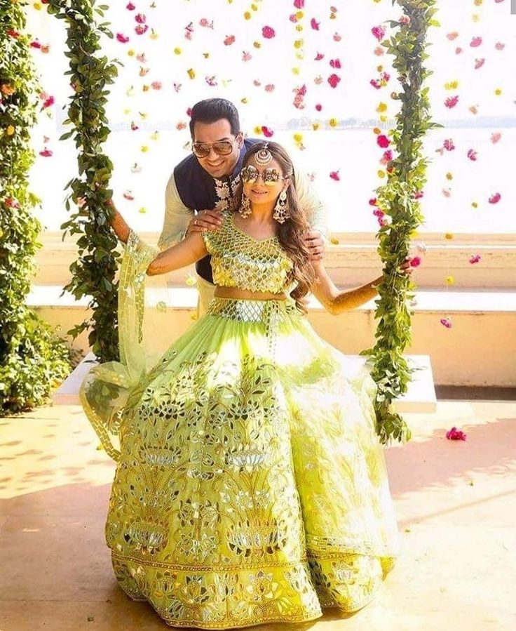 couple haldi pose on swing