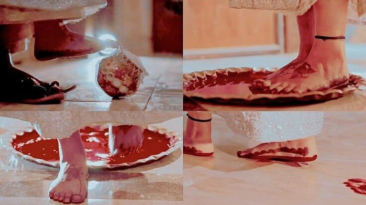 Bride stepping into new home during traditional post wedding rituals India