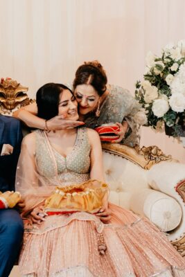 Bride smiling during mooh dikhai ritual in post wedding rituals traditions
