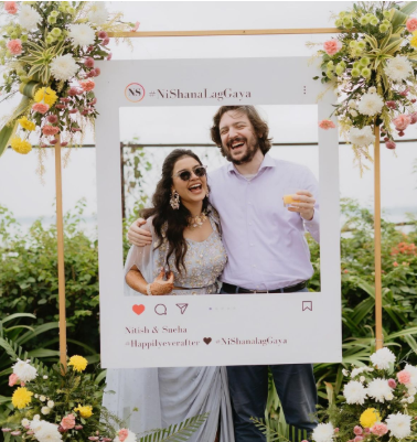 instagram themed wedding photo booth with custom frame and printed guest photos display wall