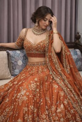 Bridal lehenga colours in rust orange with traditional motifs for a modern classic bride