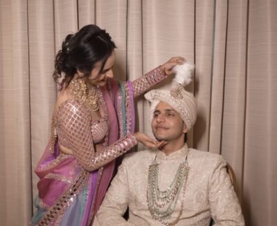 Indian wedding ritual of sehra bandi with sisters teasing the groom